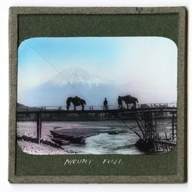Two horses and figures on bridge in front of Mount Fujiyama