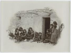 Women and children in front of a building