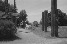[View of canoe log and totem poles]