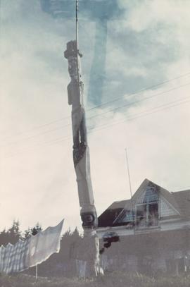 Leaning totem pole in front of house