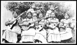 Group portrait of seven women playing musical instruments