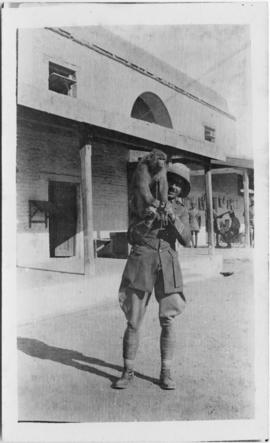 Soldier holding a monkey