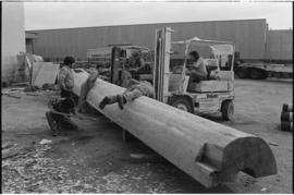 Crew moving log from the Turnbull & Gail construction yard in Richmond (contractors for build...