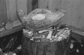 [Tree stump with carving and tools]