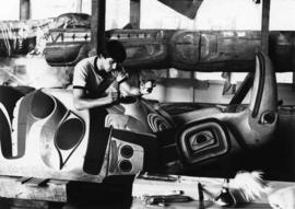 Jim M. Hart working on a totem pole