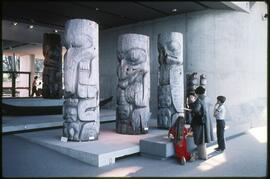 Children viewing totem poles in the Museum of Anthropology