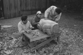 [Chip, Isaac, and Ron continue shaping large beaver bowl carving]