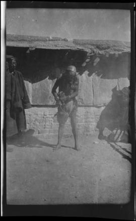 Unidentified man standing in front of building