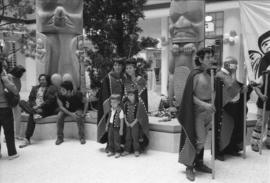 [Isaac Tait with unidentified persons in front of totems]