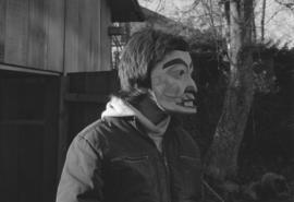 [Profile of unidentified person wearing mask]
