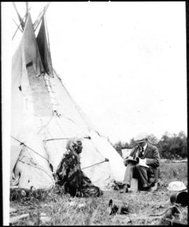 Portrait of two men in front of tipi, view one