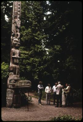 Museum staff discuss moving a totem pole
