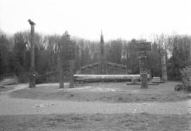 [Wide shot of MOA grounds, Mortuary House, totems and canoe log]