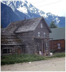 House in unidentified village, with mountains