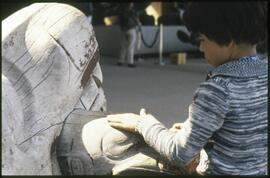 A child play with the Wasgo sculpture