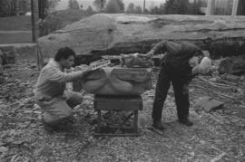 [Ron and Isaac assess large beaver bowl carving]