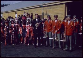 Brass band in uniform and children in ceremonial dress