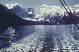 View from fishing boat on water, looking toward large mountains