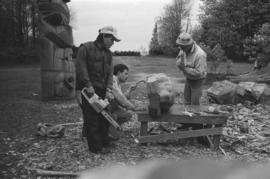 [Isaac, Ron, and Chip continue shaping large beaver bowl carving]