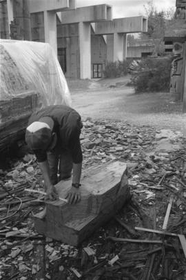 [Isaac measures large beaver bowl carving]