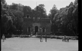 Stone building and people with horse cart