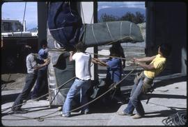 A totem pole being moved into the Museum of Anthropology