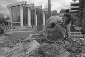 [Ron uses chainsaw to continue shaping log]