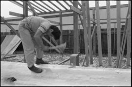 Crew working on log at the Turnbull & Gail construction yard in Richmond (contractors for bui...