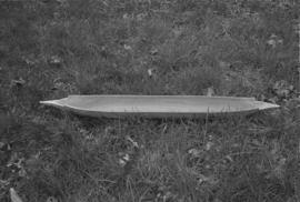 [Model canoe in grass]
