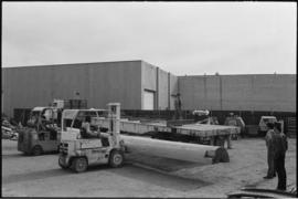 Crew moving log from the Turnbull & Gail construction yard in Richmond (contractors for build...