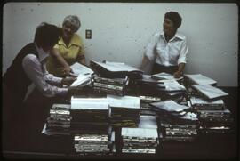 Museum staff reviewing museum catalogues