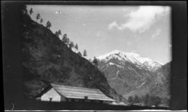 Building, Mountains, Trees and Sky