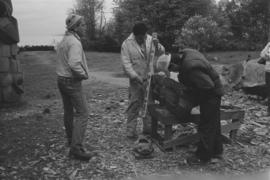 [Chip, Ron, and Isaac measure large beaver bowl carving]