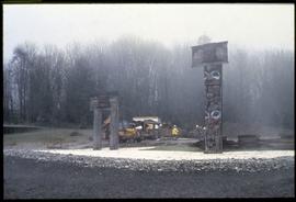 Haida house and mortuary house being reassembled