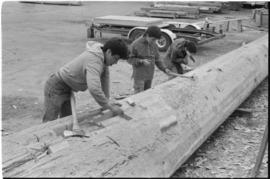 Crew working on log at the Turnbull & Gail construction yard in Richmond (contractors for bui...