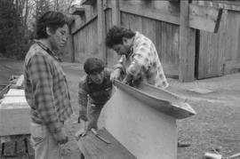 [Chip, Norman and Ron inspect model canoe]