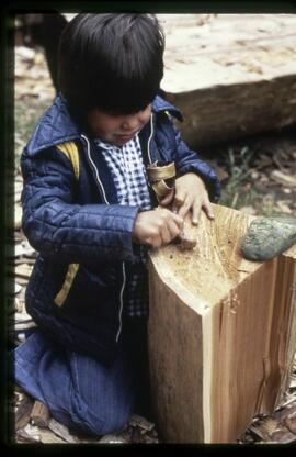 Child with strip of bark