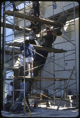 Workers raising a totem pole in the Museum of Anthropology