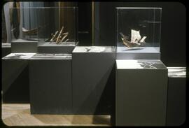 Model canoes, hooks, and photographs on display
