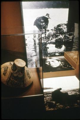 Basket-work hat and photographs on display in Montréal